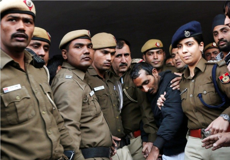 Policemen escort driver Shiv Kumar Yadav who is accused of a rape outside a court in New Delhi