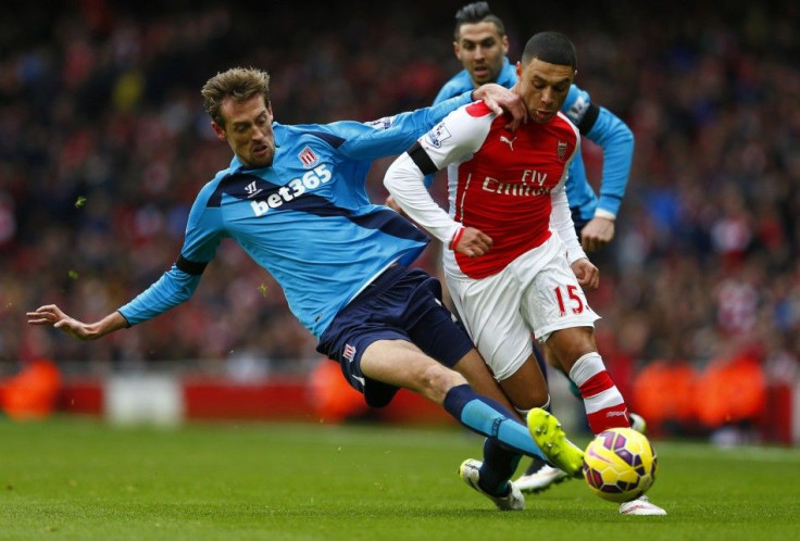 Stoke City&#039;s Peter Crouch (L) challenges Arsenal&#039;s Alex Oxlade-Chamberlain during their English Premier League soccer match at the Emirates Stadium in London January 11, 2015.