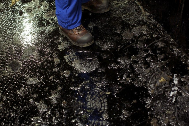 DATE IMPORTED:September 23, 2014A work boot walks on the oil covered floor at the Suncor processing plant at their tar sands operations near Fort McMurray, Alberta, September 17, 2014. In 1967 Suncor helped pioneer the commercial development of Canada&#03