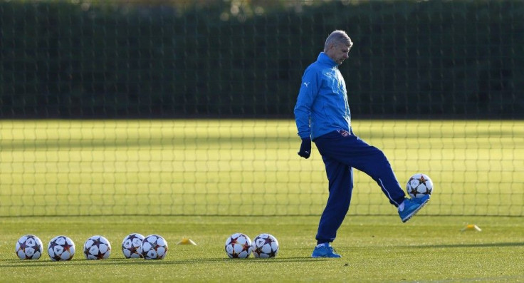 Arsenal manager Arsene Wenger controls a ball during a training session ahead of their Champions League soccer match against Galatasaray, at their training facility in London Colney, north of London December 8, 2014.