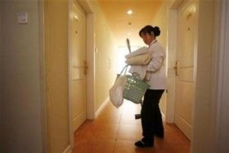 A maid leaves a room after cleaning it