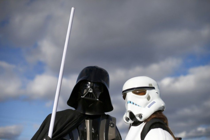 Attendees pose as Darth Vader and a stormtrooper outside the MCM Comic Con