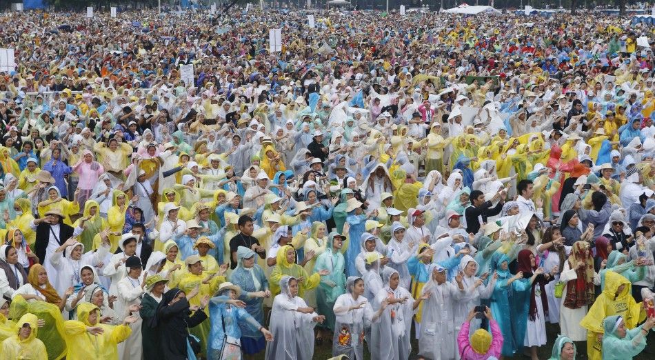 Nuns and Catholic faithful dance as they wait for a Mass by Pope Francis at Rizal Park in Manila January 18, 2015. Huge crowds converged on a Manila park on Sunday to see Pope Francis wrap up his Asian trip with an outdoor Mass expected to draw one of the