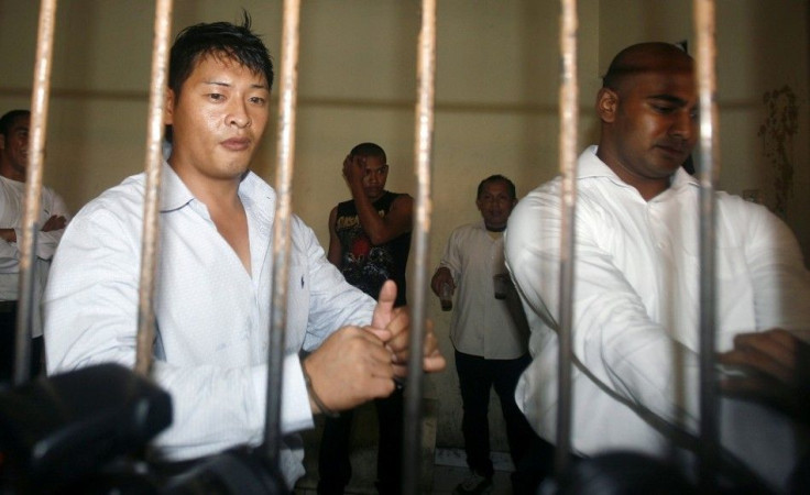 IN PHOTO: Australian Andrew Chan (L) and Myuran Sukumaran wait in a temporary cell for their appeal hearing in Denpasar District Court in Indonesia's resort island of Bali September 21, 2010.