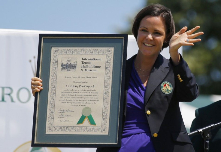 Former tennis player Lindsay Davenport of the United States waves and holds her plaque after being inducted into the International Tennis Hall of Fame in Newport, Rhode Island July 12, 2014. REUTERS/Brian Snyder