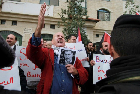 A Palestinian man chants slogans against Canadian Foreign Minister John Baird as Baird meets with his Palestinian counterpart in the West Bank city of Ramallah