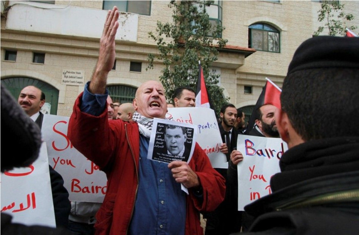 A Palestinian man chants slogans against Canadian Foreign Minister John Baird as Baird meets with his Palestinian counterpart in the West Bank city of Ramallah