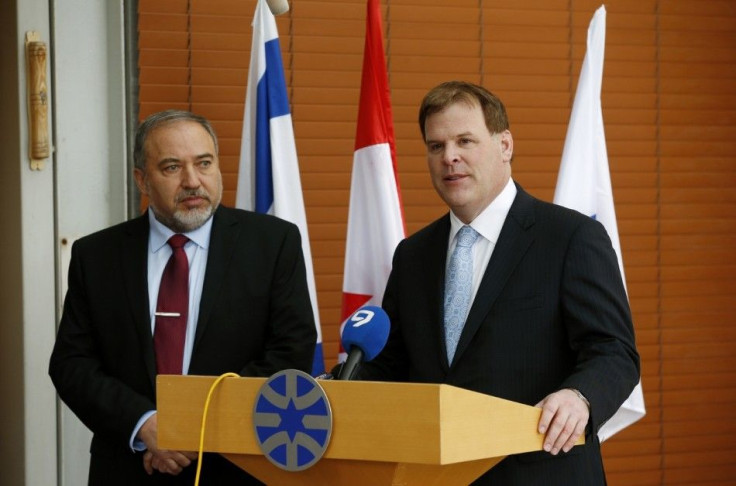 Canadian Foreign Minister John Baird (R) and his Israeli counterpart Avigdor Lieberman deliver joint statements to the media before their meeting in Jerusalem January 18, 2015. Palestinian protesters heckled and threw eggs at Baird during a visit to the o