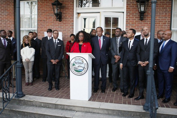 Oprah Winfrey (C), producer and cast member of the movie &quot;Selma&quot;, addresses the residents along with politicians and other cast members at City Hall in Selma,