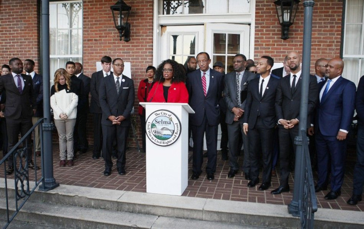 Oprah Winfrey (C), producer and cast member of the movie "Selma", addresses the residents along with politicians and other cast members at City Hall in Selma,