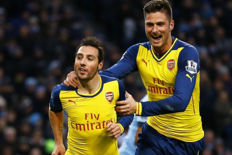 Arsenal's Santi Cazorla (L) celebrates his goal from a penalty with teammate Olivier Giroud during their English Premier League soccer match against Manchester City at the Etihad stadium in Manchester, northern England January 18, 2015.