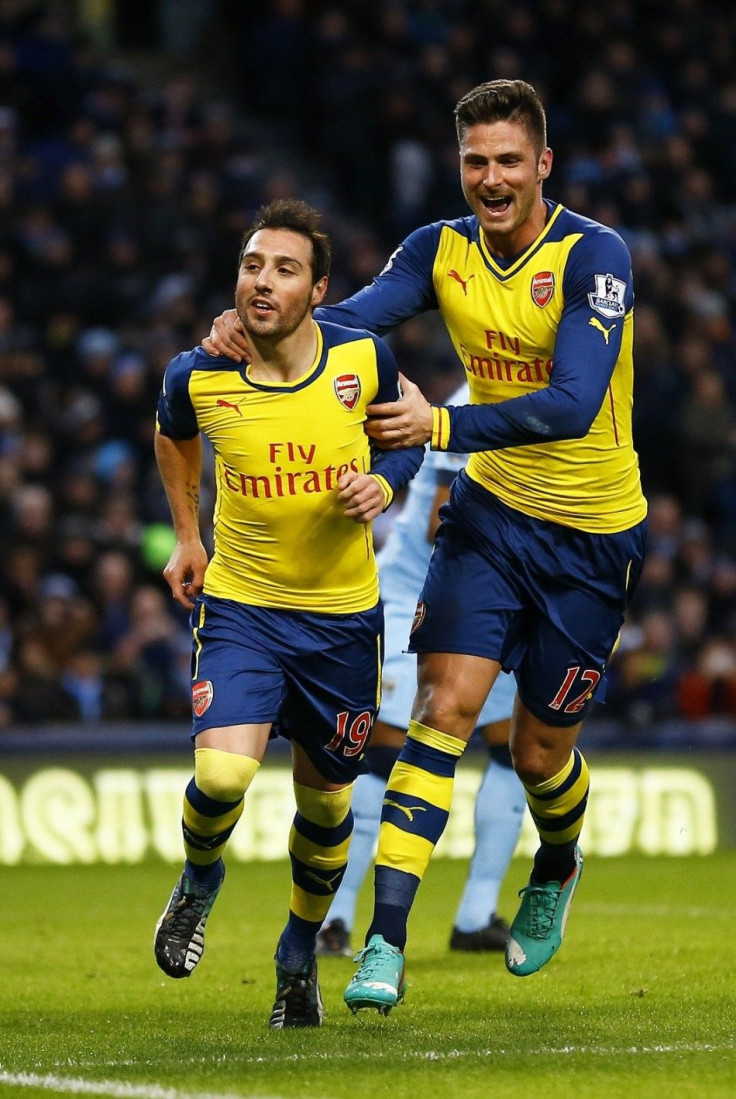 Arsenal's Santi Cazorla (L) celebrates his goal from a penalty with teammate Olivier Giroud during their English Premier League soccer match against Manchester City at the Etihad stadium in Manchester, northern England January 18, 2015.