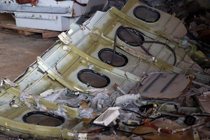 Part of the fuselage of crashed AirAsia Flight QZ8501 is seen inside a storage facility at Kumai port in Pangkalan Bun, January 19, 2015. The airliner lost contact with air traffic control in bad weather on December 28, 2014, less than halfway into a two-