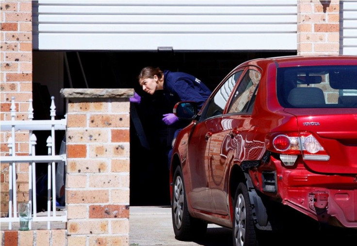 A member of the Australian Federal Police (AFP) forensic unit inspects a garage at a house that was involved in pre-dawn raids in the western Sydney suburb of Guilford