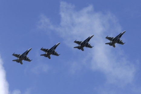 Canadian Air Task Force jets CF-18 fly over Siauliai air base August 26, 2014. The Royal Canadian Air Force will hand over their air policing mission over the Baltics to NATO in September 1, 2014. REUTERS/Ints Kalnins