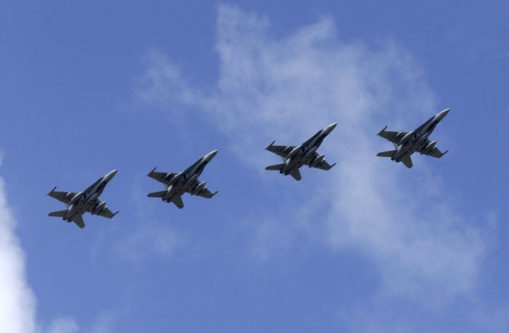 Canadian Air Task Force jets CF-18 fly over Siauliai air base August 26, 2014. The Royal Canadian Air Force will hand over their air policing mission over the Baltics to NATO in September 1, 2014. REUTERS/Ints Kalnins