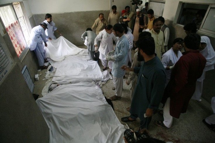 Relatives, rescue workers and medic stand near the bodies of victims, who were killed in a bomb blast, at a hospital in Quetta June 15, 2013. Militants in a volatile region of western Pakistan bombed a bus carrying women students on Saturday and then seiz