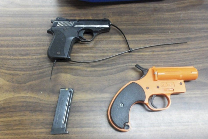 A handout photo provided by the New York Police Department January 18, 2013 shows a .22 caliber handgun, an ammunition clip and a flare gun that was found in the backpack of a 7-year old boy at a elementary school in New York Thursday.