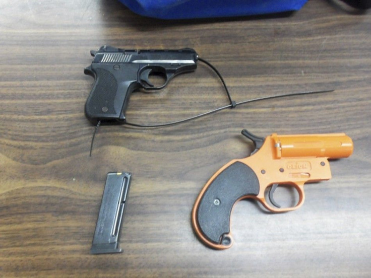 A handout photo provided by the New York Police Department January 18, 2013 shows a .22 caliber handgun, an ammunition clip and a flare gun that was found in the backpack of a 7-year old boy at a elementary school in New York Thursday.