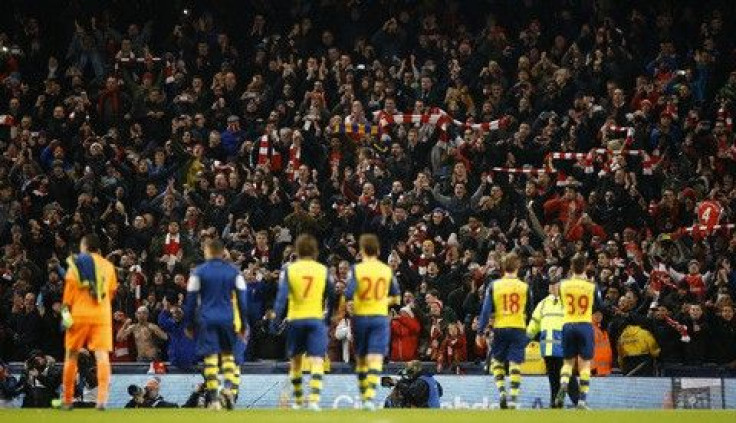 Arsenal fans celebrate their team&#039;s victory after the final whistle of their English Premier League soccer match against Manchester City at the Etihad stadium in Manchester, northern England January 18, 2015. Arsenal won 2-0.