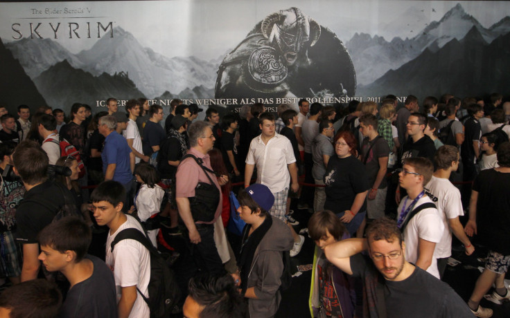 Visitors stand in front of the "Skyrim'' exhibition stand during the Gamescom 2011 fair in Cologne August 17, 2011. The Gamescom convention, Europe's largest video games trade fair, runs from August 17 to August 21.   REUTERS/Ina Fassbender