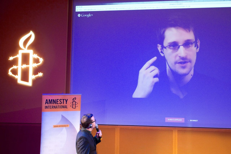 Former U.S. National Security Agency contractor Edward Snowden, who is in Moscow, is seen on a giant screen during a live video conference for an interview as part of Amnesty International's annual Write for Rights campaign at the Gaite Lyrique in Paris D