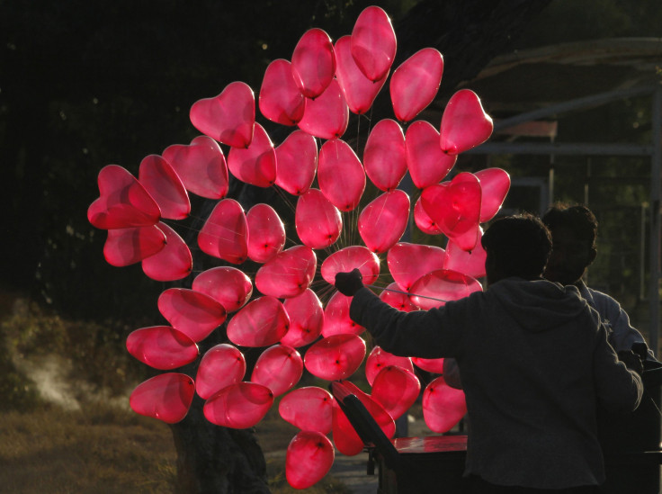 A man is silhouetted as he fills heart shaped balloons with helium while waiting for customers on Valentine's Day in Islamabad February 14, 2012.    