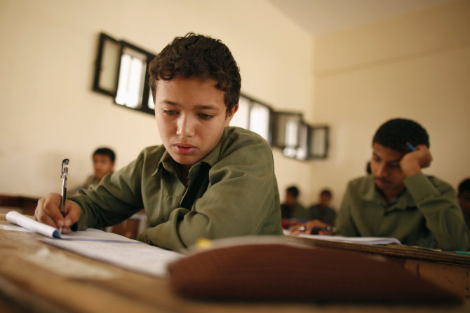 Students take the final examination of their primary school in Sanaa June 25, 2013. The final examination is held during the 9th grade of primary education in Yemen. 