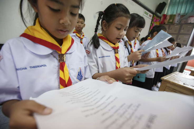 Students read during their class at a school in Bangkok October 30, 2014.