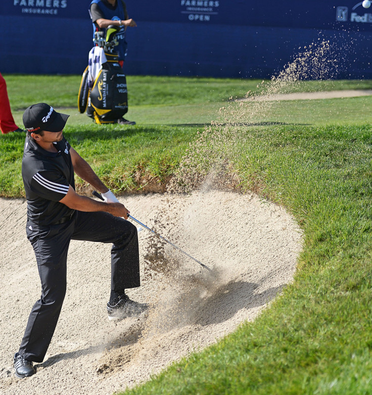 Jason Day plays out of a greenside bunker on the 17th