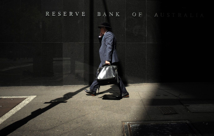 A Sydney businessman walks into the light outside the Reserve Bank of Australia (RBA)