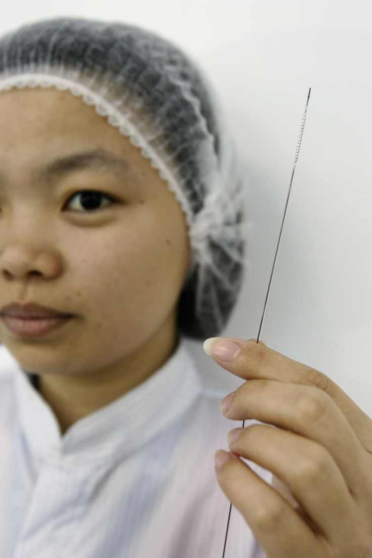 A lab technician poses with a stent