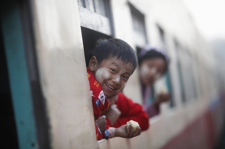A boy smiles from a train bound for Mandalay at the Myitkyina station in Myanmar's northern Kachin State on February 25, 2012. 