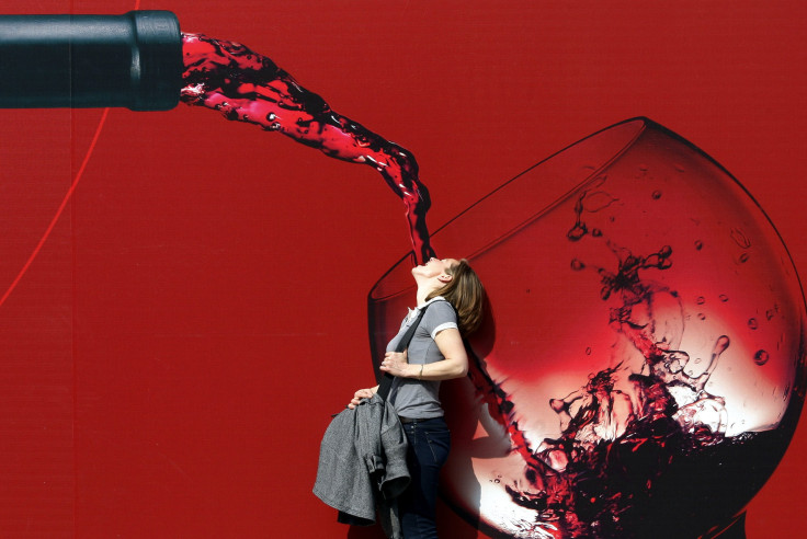 A woman poses for a picture at the Vinitaly wine expo in Verona