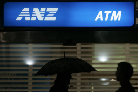 Office workers pass an ANZ Bank sign in central Sydney April 24, 2008.