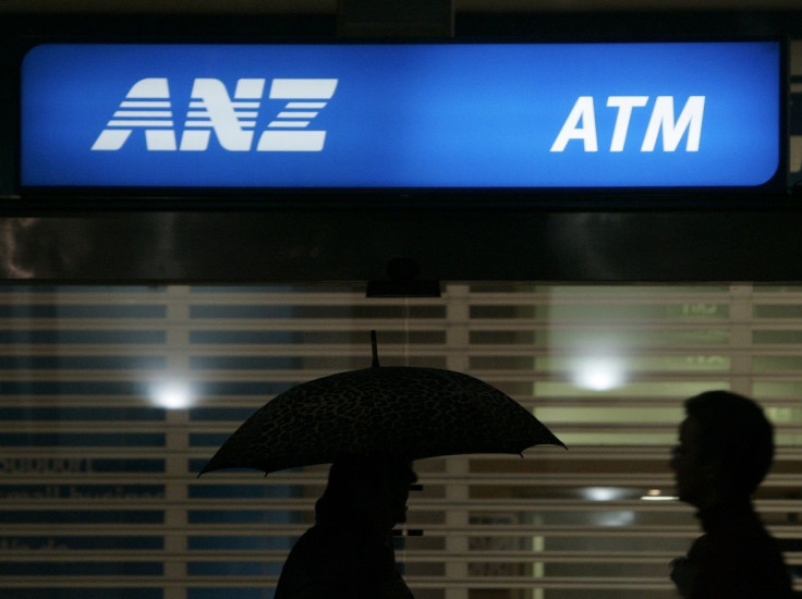 Office workers pass an ANZ Bank sign in central Sydney April 24, 2008.