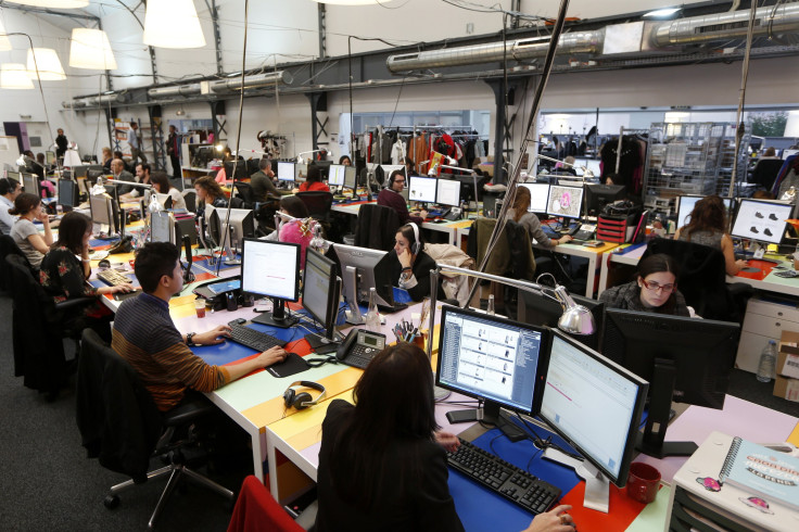 Employees work in front of their computers at the Vente-Privee.com company's headquarters in Saint-Denis near Paris October 24, 2013. 
