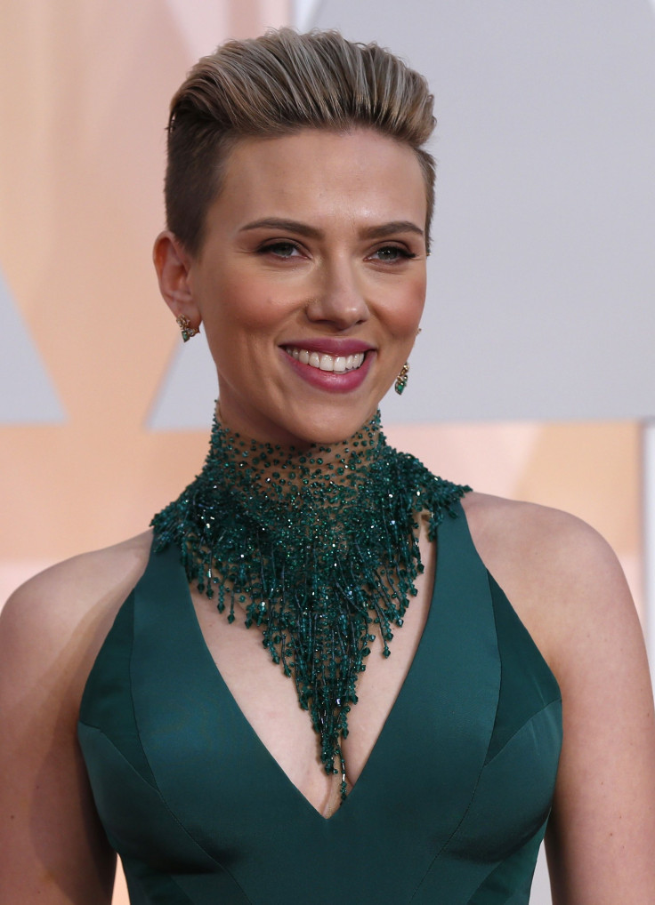 Actress Scarlett Johansson wears a Versace gown as she arrives at the 87th Academy Awards