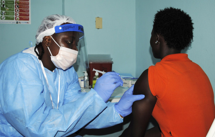 A health worker injects a woman with an Ebola vaccine during a trial in Monrovia
