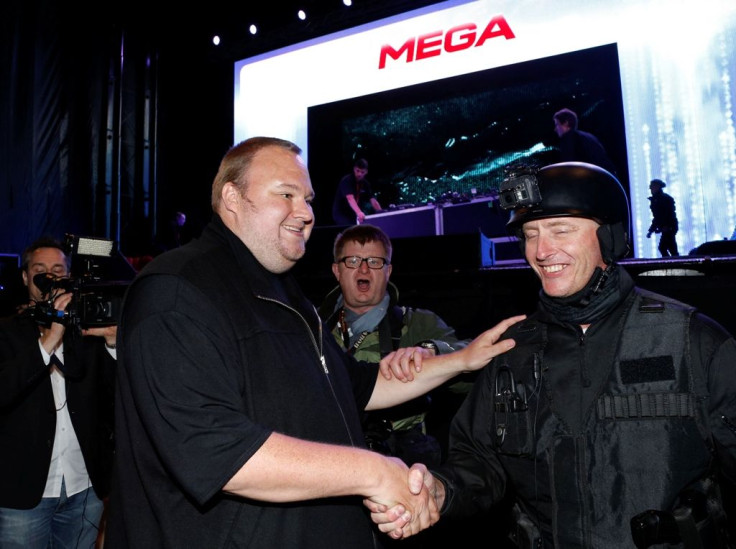 An actor in police costume greets Megaupload founder Kim Dotcom (L) as he launches his new file sharing site "Mega" in Auckland January 20, 2013.