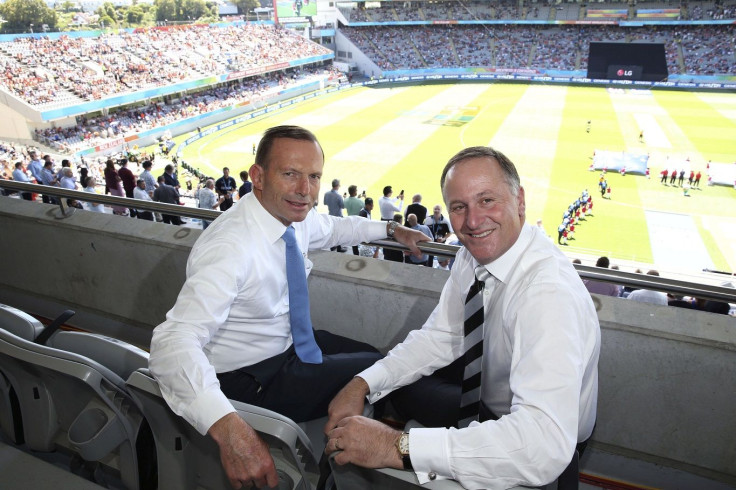 Australian Prime Minister Tony Abbott (L) and New Zealand's Prime Minister John Key smile as they attend the Cricket World Cup match between the two countries, at Eden Park in Auckland February 28, 2015.