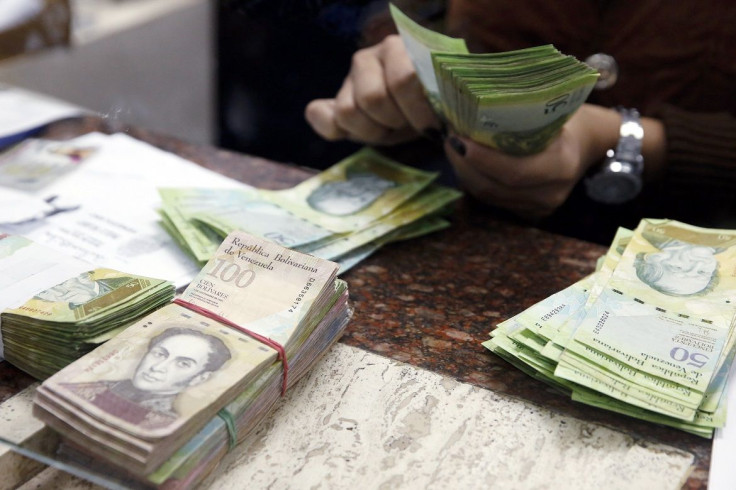 A Cashier Counts Bolivars At Money Exchange In Caracas