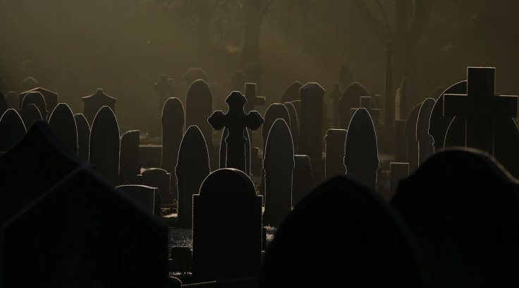 Sunlight glints off frost-covered gravestones in a cemetery in Altrincham, northern England December 28, 2014.