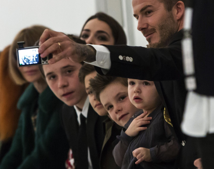 [8:01] Former England soccer captain David Beckham (R) takes a 'selfie' of himself and his children (L-R) Brooklyn, Romeo, Cruz and Harper, before the Victoria Beckham Fall 2014 
