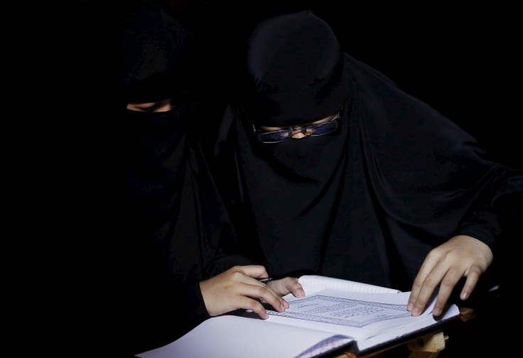 Two female Muslim students engrossed in studying