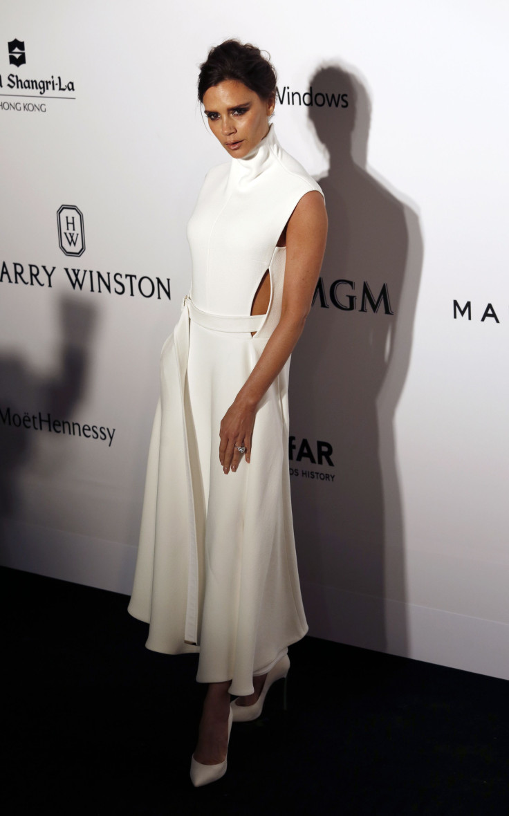 [8:06] British fashion designer Victoria Beckham poses upon arrival at the Foundation for AIDS Research's (amfAR) inaugural fundraising gala 