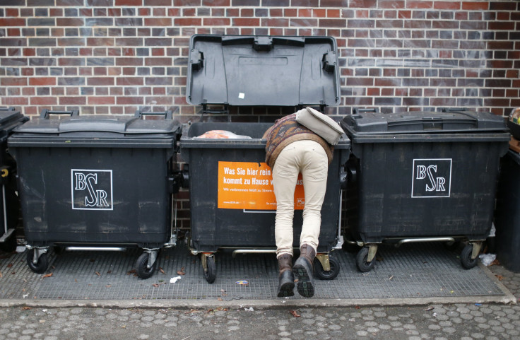 A man rummaged through a food dumpster