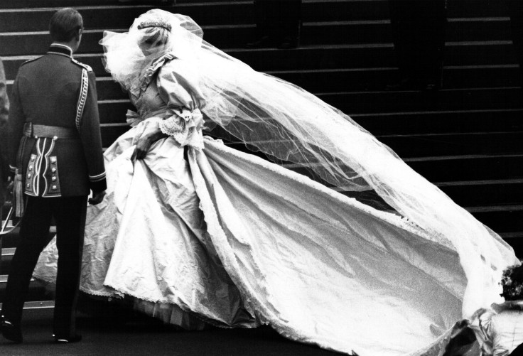 Lady Diana Spencer, soon to become the Princess of Wales, showing her wedding gown for the first time, turns as her bridesmaids set her train on arrival at Saint Paul's Cathedral for her wedding to Prince Charles in London, July 29, 1981.