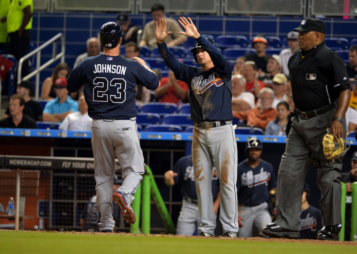 Atlanta Braves players celebrating after scoring a run.