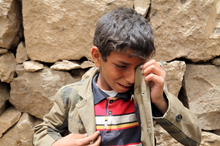 A boy cries near the rubble of houses destroyed by an air strike in the Okash village near Sanaa April 4, 2015